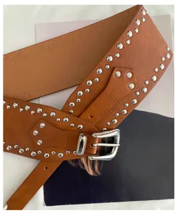 Detail shot of the American western brown leather wide belt featuring shiny silver studs and buckle.