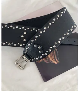 Wide black leather belt with silver metal studs, western style fashion waist accessory.