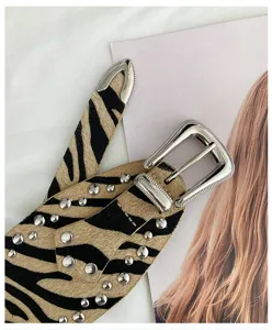Western style wide studded animal print leather belt with metal buckle and tip details.