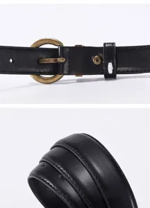 Detailed close-up view of women's black leather belt showing metal round buckle and fine texture.