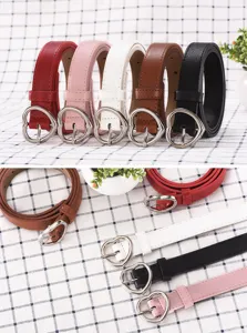 Close-up detail shot of women's leather belts featuring cute heart-shaped metal pin buckles.