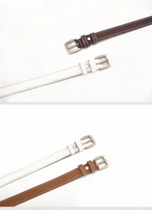 Close-up detail of women's leather belt featuring double stitching and metal pin buckle.
