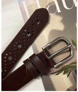 Detailed close-up view of women's dark brown leather hollow pin buckle belt texture.