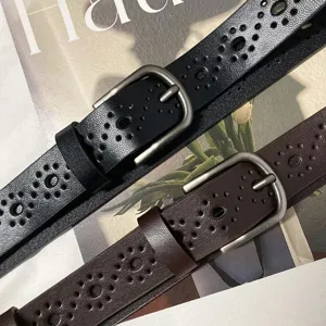 Women's leather belt with hollow out pattern and pin buckle, stylish accessory for jeans.