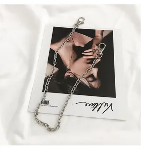 Detailed shot of a punk style silver metal pants chain, trendy hip-hop accessory flatlay.