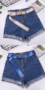 Denim shorts detail featuring high waist, button fly, rolled cuffs and canvas belt.