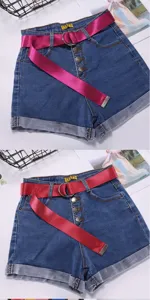 Women denim shorts with vibrant pink canvas belt featuring metal D-ring buckle, casual chic style.
