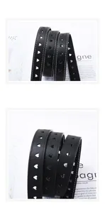 Zwarte lederen riem detailopname met hartjes uitsparingen, minimalistische damestailleband.