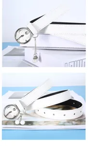 Detail view of white women belt with round silver buckle and elegant pearl pendant design.