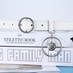 White leather belt for women with round metal buckle and smiley charm. Chic jeans accessory.