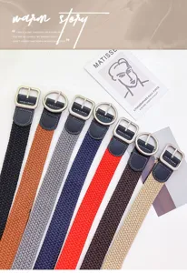 Detailed view of colorful woven canvas belts with metal buckles, versatile casual fashion accessory.