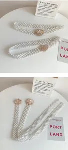 Detail view of multi-strand faux pearl waist belt with rhinestone flower buckle for dresses.
