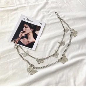 Close-up detail shot of silver double layer metal butterfly chain accessory for hip-hop style.