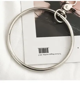 Metal ring keychain detail shot, punk style fashion accessory hardware, stylish metal O-ring.