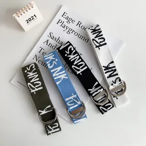 Men's canvas belt with D-ring buckle and trendy graffiti letters design, casual versatile style.