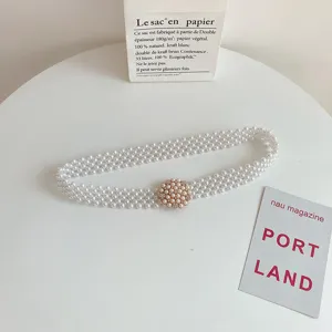 Elegant pearl waist belt for women, featuring multi-strand beaded design with rhinestone buckle.