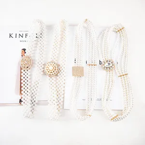 Elegant white pearl elastic waist belt for women, rhinestone metal buckle dress coat accessory.