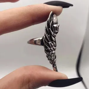 Detail view of vintage punk skull long ring in alloy, showcasing retro silver finish and wings.