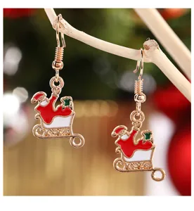 Detailansicht von Weihnachts-Weihnachtsmann-Schlitten-Ohrringen aus goldfarbener Legierung.