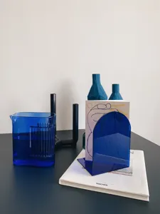 Blue acrylic arch bookend detail showing translucent material and minimalist modern desktop storage.