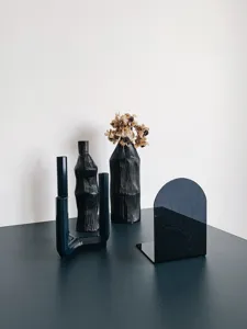 Minimalist black acrylic bookend and desktop organizer detail shot, modern home decor.