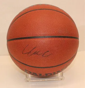 Classic orange leather basketball with black lines and logo on a clear acrylic display stand.