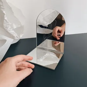 Minimalist arch folding desktop mirror with artistic wire design for home decor and vanity.
