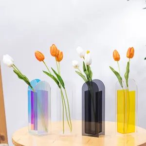 Detailed close up view of modern minimalist acrylic vases with tulips for home decor.