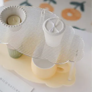 Minimalist clear acrylic desktop storage rack for cosmetics, perfume and cups in bedroom.