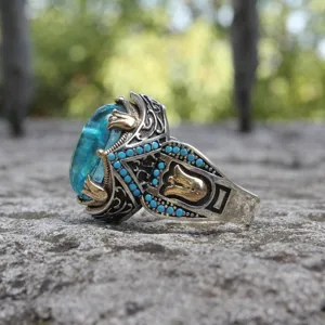 Bague vintage en pierre précieuse bleue avec filigrane argenté et accents turquoise.