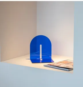 Blue acrylic arch bookend detail, minimalist desktop book organizer showcasing material and shape.