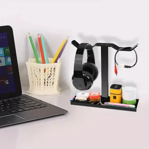Black acrylic headphone stand with desk organizer base for gaming headsets and accessories.