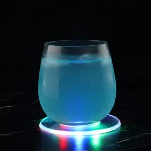 Detail shot of a glowing LED acrylic coaster featuring colorful lighting and a beverage glass.