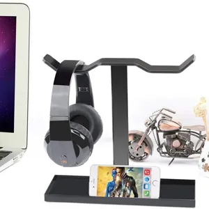 Black acrylic dual headphone stand desk organizer with phone holder tray and cable storage.