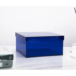 Blue acrylic desktop storage box detail, modern minimalist plastic organizer container with lid.
