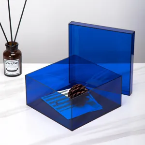 Modern minimalist solid blue transparent acrylic desktop storage box with lid for home decor.