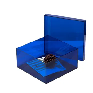 Modern minimalist transparent blue acrylic desktop storage box with lid for home organization.