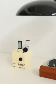 Acrylic remote control holder desk organizer detail view with stylish yellow finish.
