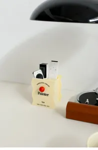 Detailed view of acrylic wavy desktop storage box with red knob and retro typography.