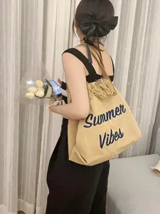 Korean style canvas tote bag with chic tassels and blue summer embroidery for daily commute.
