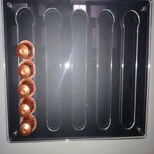 Acrylic wall-mounted coffee capsule holder display rack for office and home bar use.