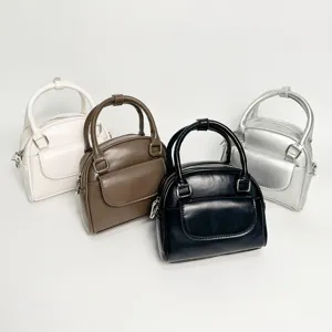 Details view of the multi-color mini handbag showcasing sleek leather texture and hardware.