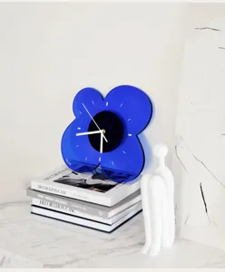 Detail view of modern Klein blue acrylic flower wall clock, minimalist home decor clock.