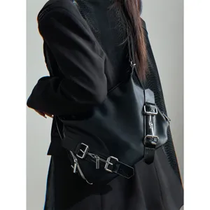 Detailed view of the edgy black multi-use backpack showcasing metallic buckles and zippers.