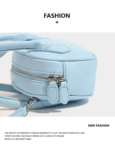 Light blue leather bowling bag detail view featuring dual metal zippers and handles