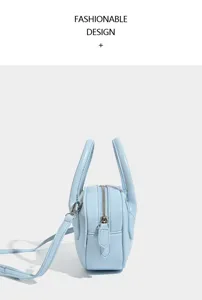 Light blue bowling bag side detail, premium leather texture, smooth zipper and handle design.