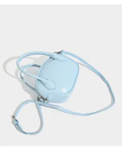 Light blue mini bowling bag detail, featuring top handles and adjustable strap.