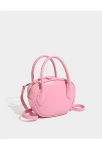 Pink bowling bag detail showing smooth leather texture, sturdy handles and crossbody strap.