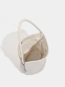 Minimalist soft leather bucket bag in white, elegant single handle handbag for women daily wear.