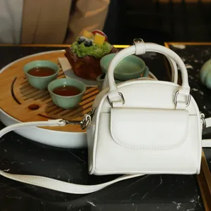 White mini shell handbag for women, chic retro crossbody bag with top handle and strap.